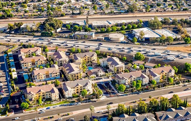 an aerial view of an urban area with cars on a freeway