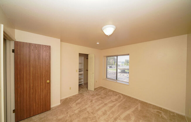 Bedroom with a walk-in closet with wardrobe organizers