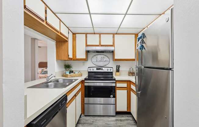 A kitchen with a stainless steel refrigerator and a stove top oven.
