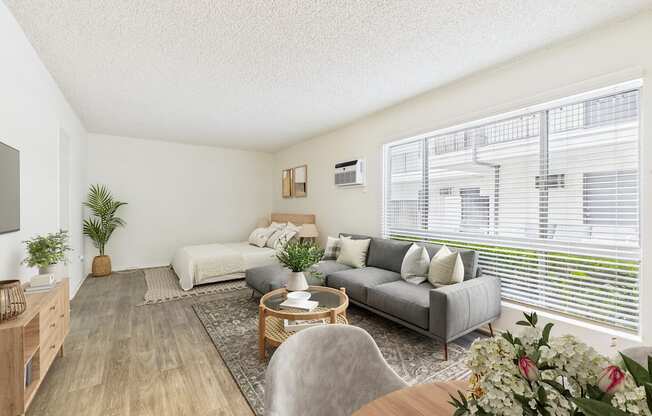 A modern kitchen with a dining table set with a vase of flowers and pears.