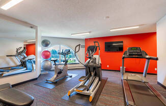 a gym with exercise equipment and a view of the city