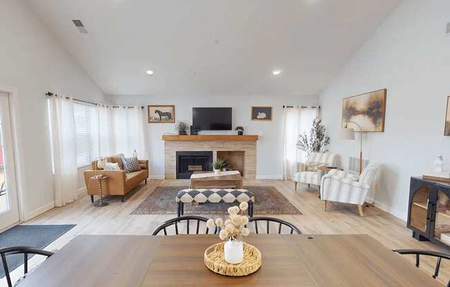 A living room with a fireplace and a television on the wall.