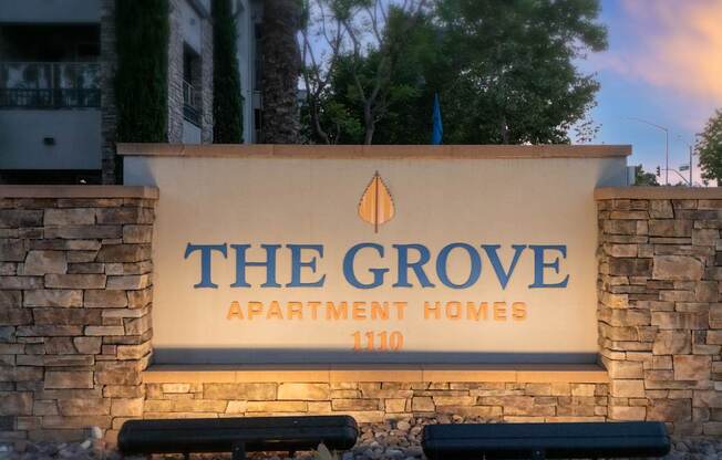 The Grove Apartment Homes sign in front of a building.