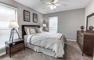 a bedroom with a bed and a ceiling fan