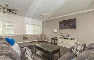 a living room with a couch and a coffee table at Villa La Paz Apartments, California