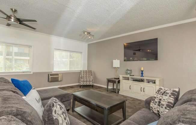 a living room with a couch and a coffee table at Villa La Paz Apartments, California