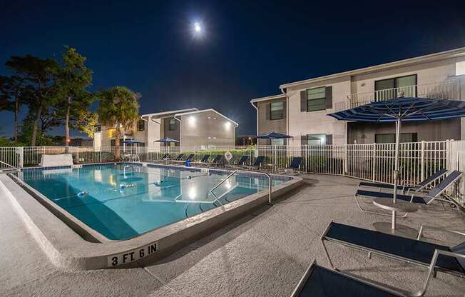 Community Swimming Pool with Pool Furniture at Arbors at Orange Park Apartments located in Orange Park, FL.