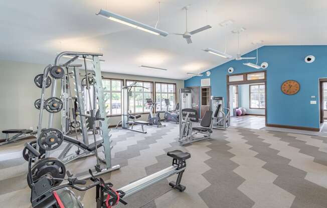 a fitness center with exercise equipment and windows