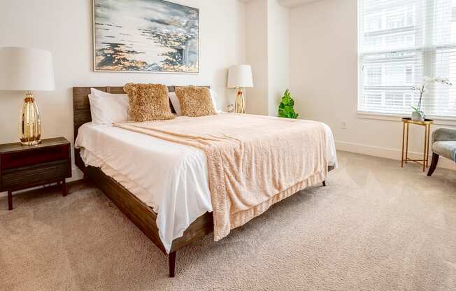 a bedroom with a bed and two windows