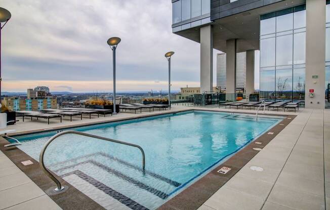 A large indoor swimming pool with a view of the city.
