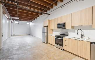 A kitchen with wooden cabinets and stainless steel appliances.