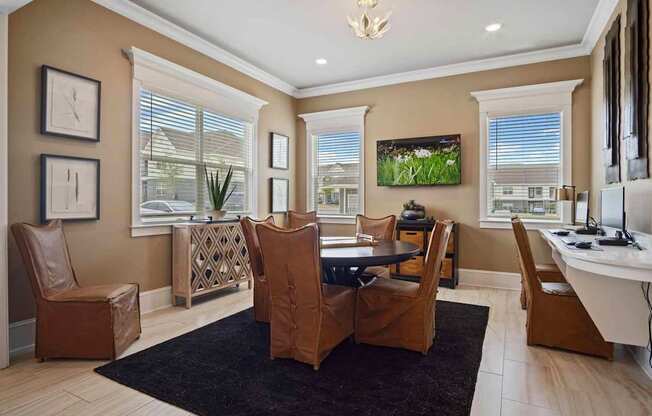 A living room with brown leather chairs and a black rug.