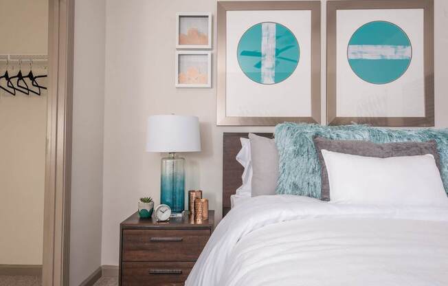 a bedroom with a bed and pictures on the wall above it