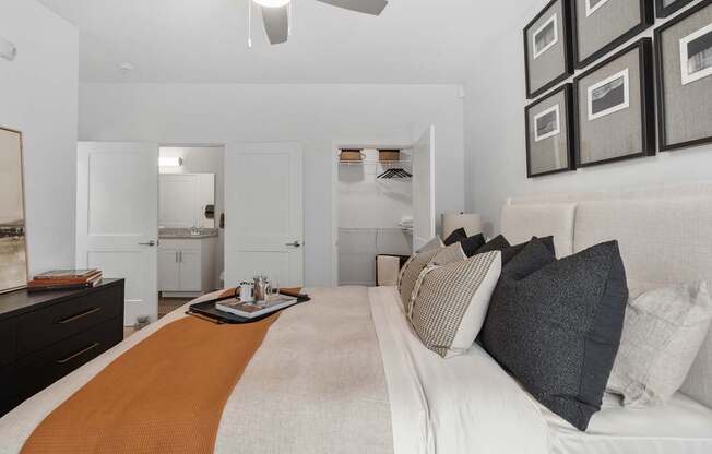 A bedroom with a bed, dresser, and mirror.