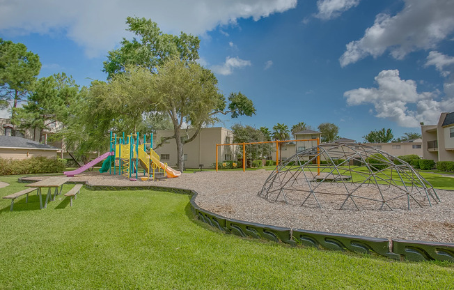 View of Playground, Showing Swing Set, Slides, and Picnic Table at The Regatta Apartments