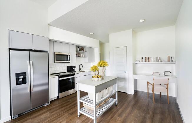 A light-cabinet kitchen with a movable island offers flexible, effortless living throughout your Modera Encore Tampa home.