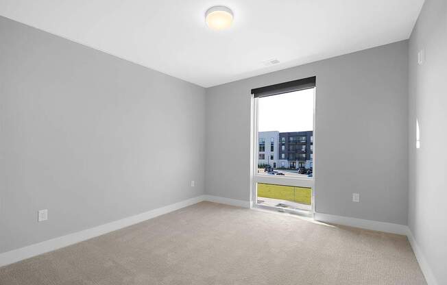 A room with a window showing a cityscape outside.