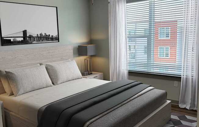 A bedroom with a large bed and a painting of a bridge on the wall.