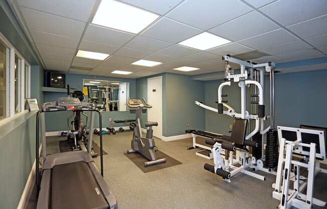 a fitness room with weights and other exercise equipment