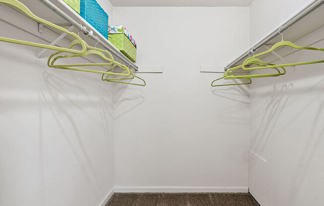 a white closet with yellow cords hanging on the wall