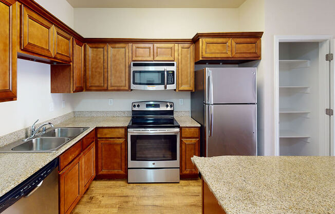 a kitchen with wooden cabinets and stainless steel appliances