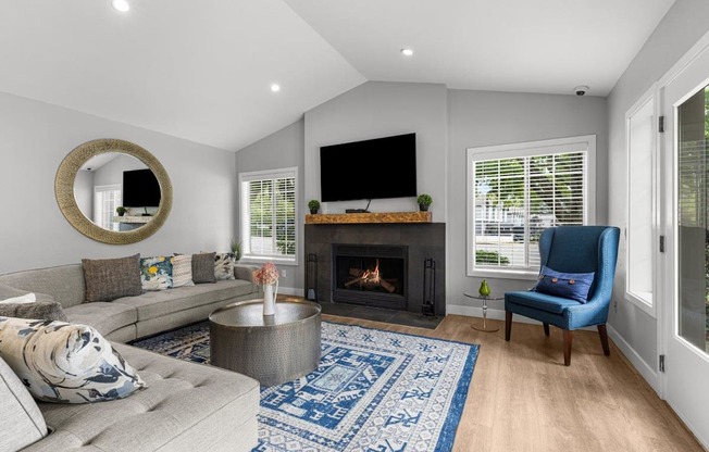 a living room with a couch and a chair and a fireplace