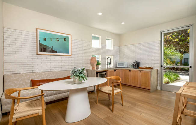 A dining area with a white table and chairs.