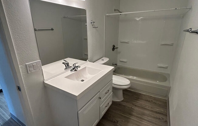 a bathroom with a sink and a toilet and a mirror at Kings Court, Anchorage, AK 99501 ? 