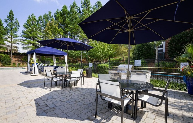a patio with tables and umbrellas