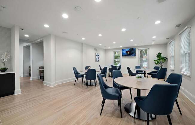 A modern dining room with a round table and chairs.