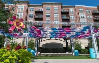 colorful umbrellas in front of an apartment building