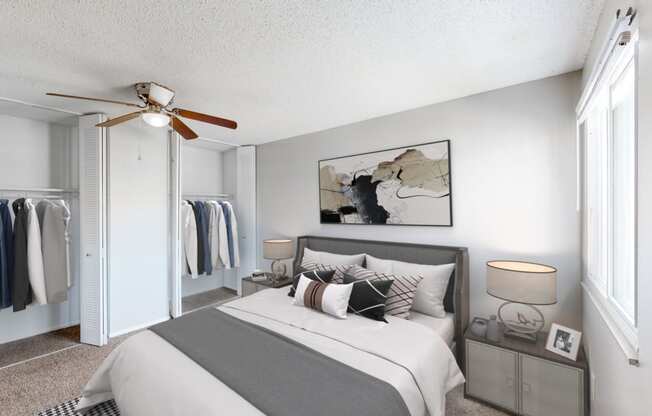 a bedroom with a bed and a ceiling fan