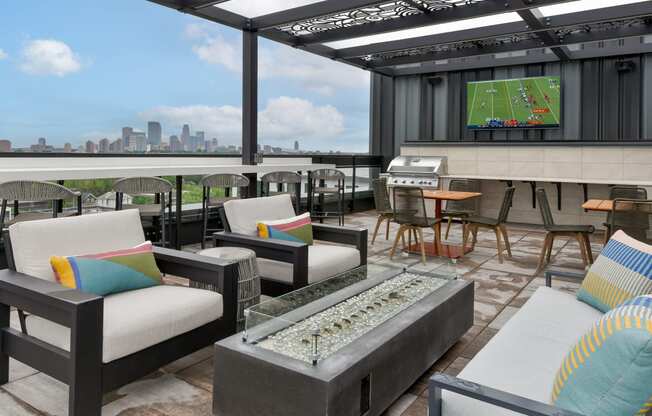 a rooftop patio with couches and tables and a televisionat The Bohen Apartments , Minneapolis, MN, 55408