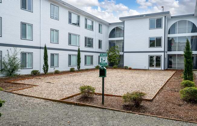 an empty parking lot in front of an apartment building