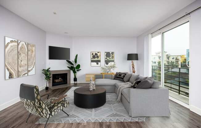 a living room with a gray couch and a black coffee table