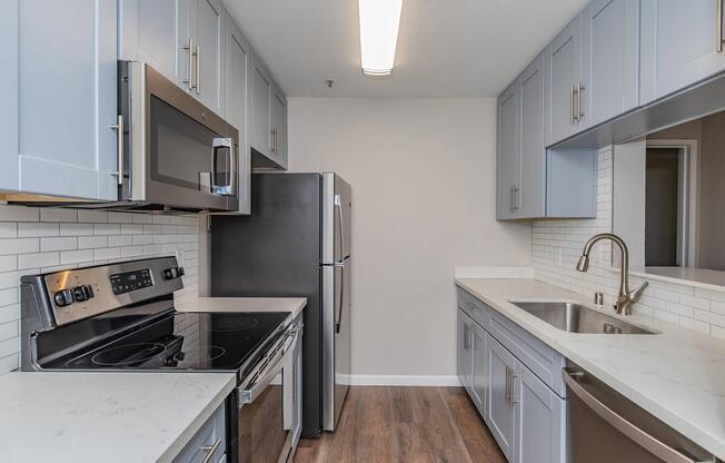 a kitchen with a sink and a stove top oven