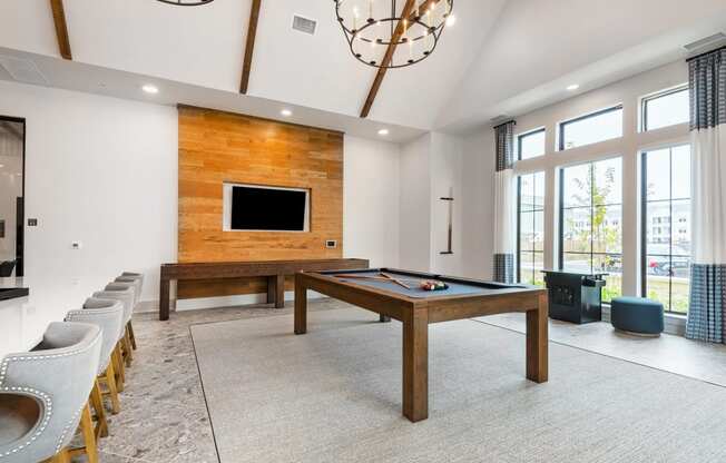 a game room with a pool table and a television