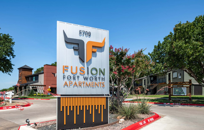 fusion Fort Worth apartments monument sign with apartment logo and modern green and grey color scheme