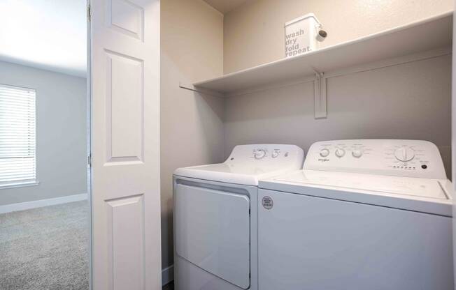 a washer and dryer in a laundry room with a closet