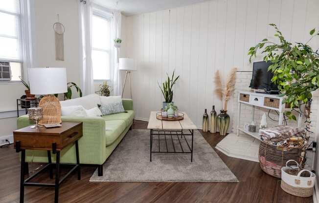 a living room with white walls and a green couch