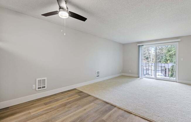 A room with a ceiling fan and a window.