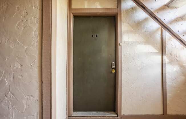 the front door of a hotel room with a green door