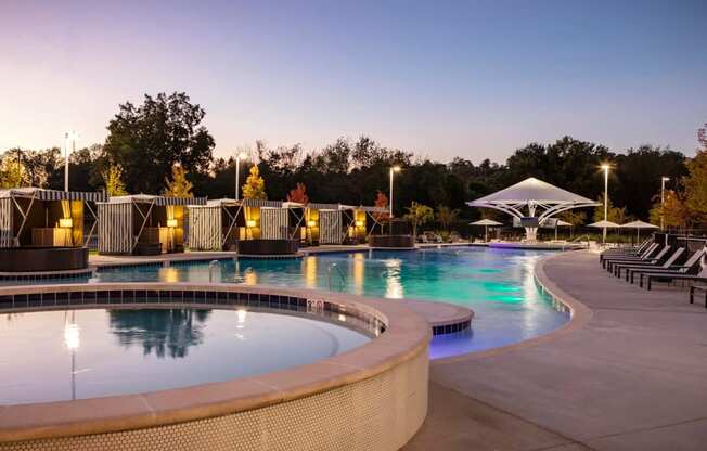a swimming pool at night at the resort at governors island at Esplanade District Apartments, Little Rock, 72114