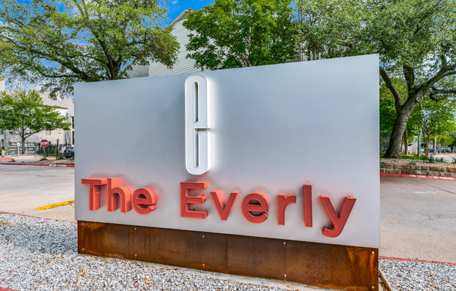 a sign for the everly on the side of a street