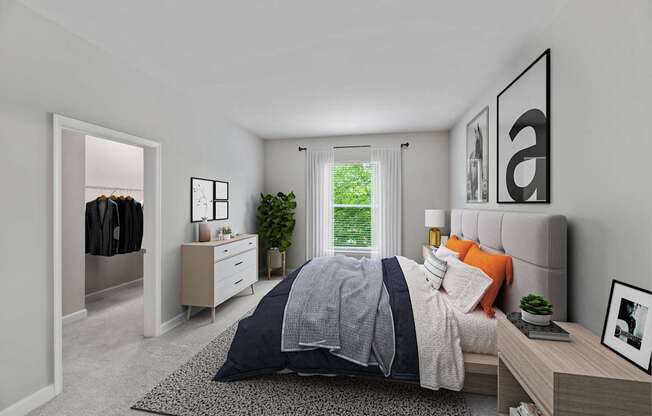 A bedroom with a bed, nightstand, and a window with a view of greenery outside.