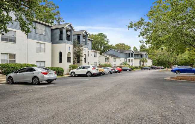 a street with cars parked in front of apartment buildings