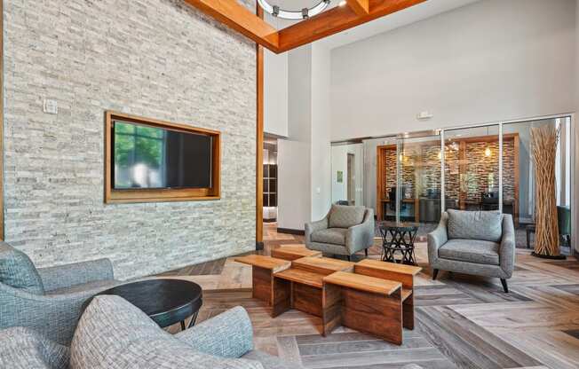 a living room with a couch and chairs and a coffee table