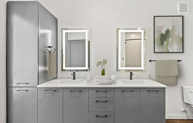 A bathroom with two sinks and a large mirror.