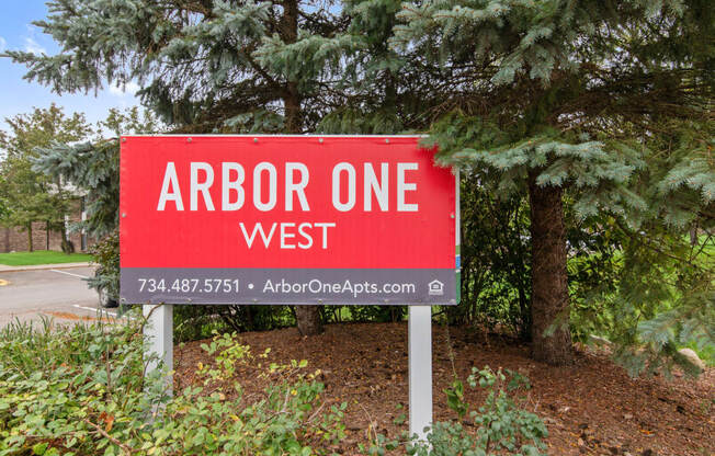a sign that reads arbor one west in front of trees