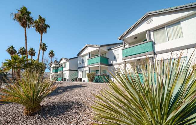 a row of houses with palm trees in front of them